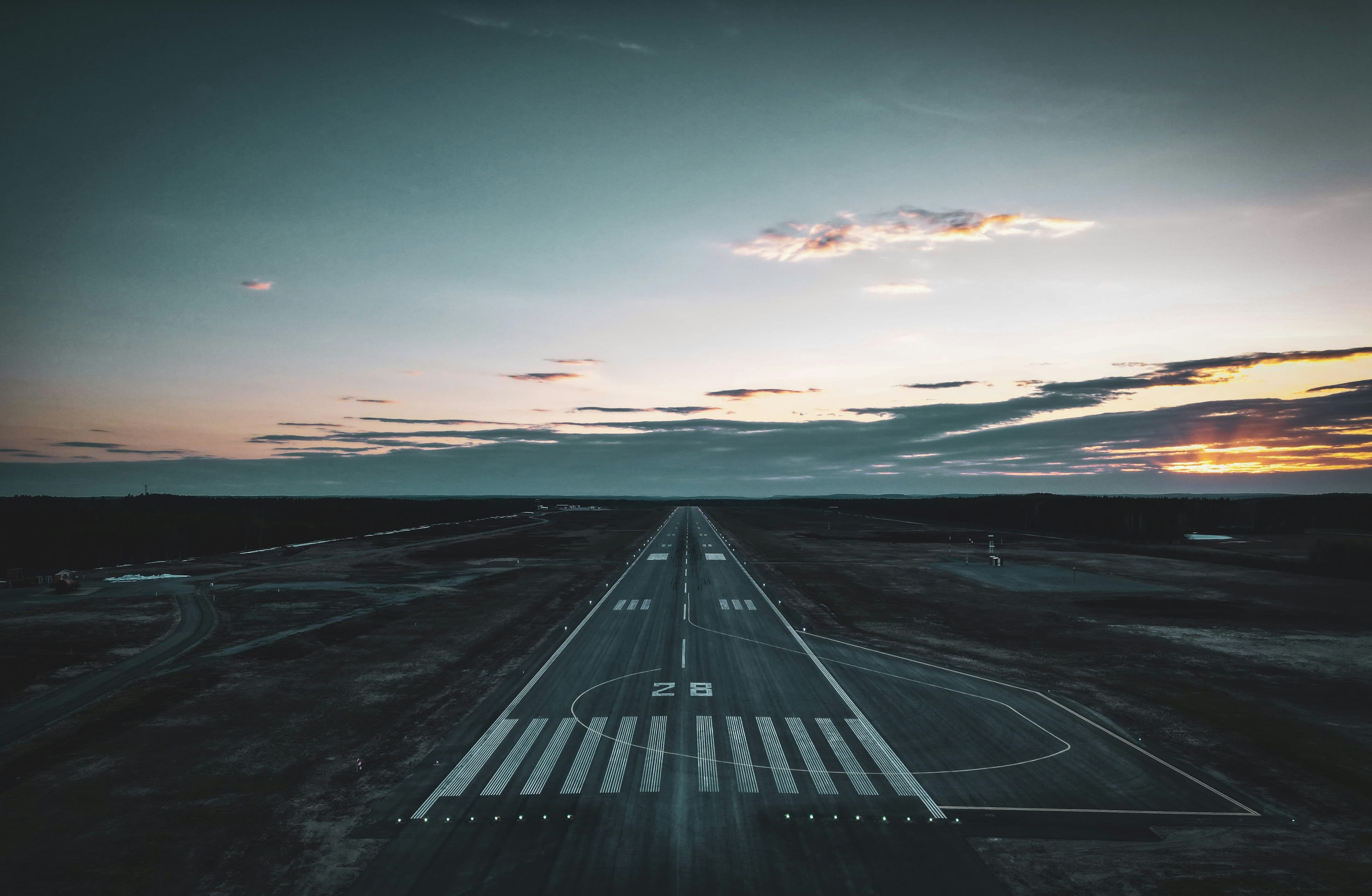 Aircraft positioned on a runway at dusk